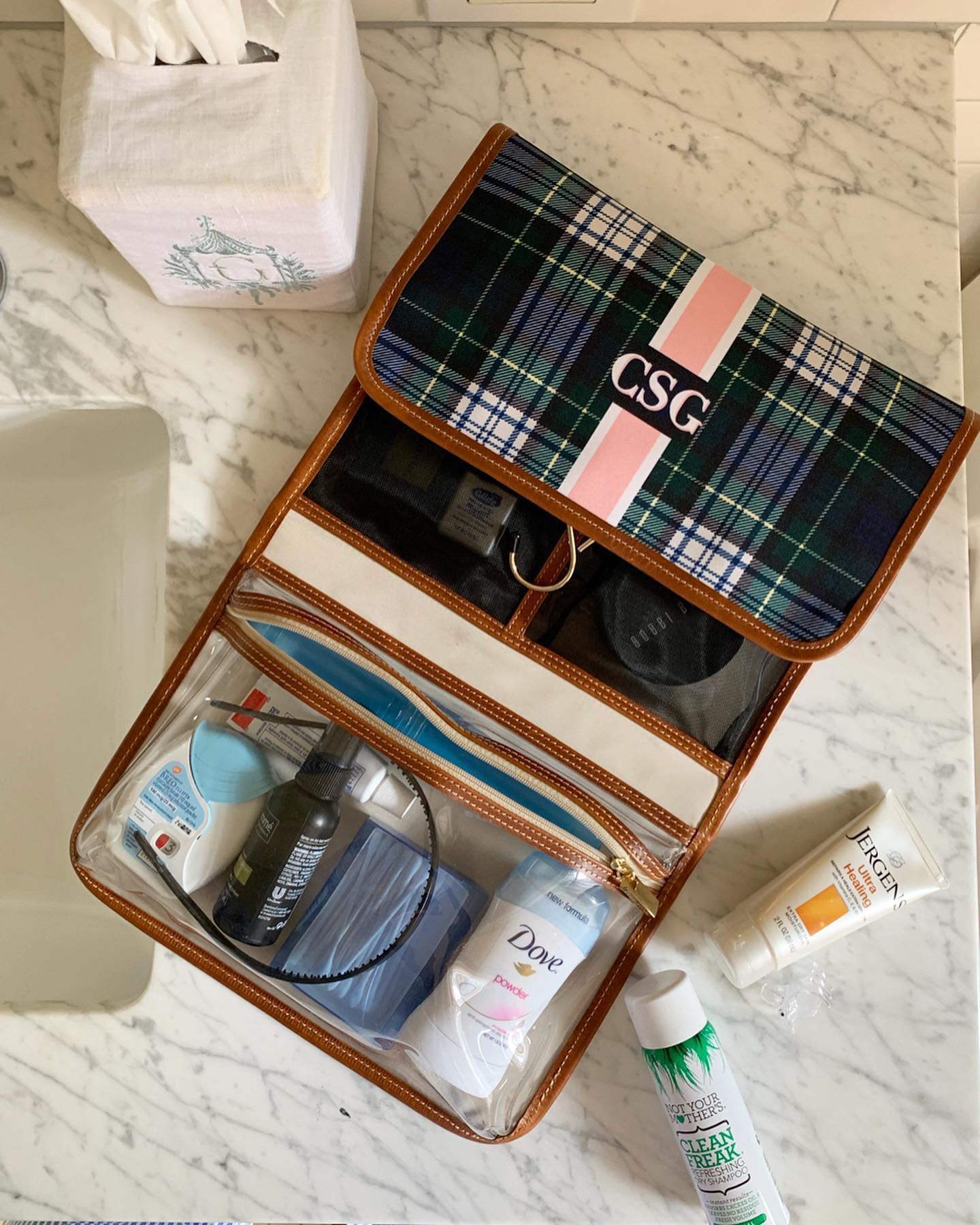Durable hanging toiletry kit filled with products, demonstrating ample storage and organization.