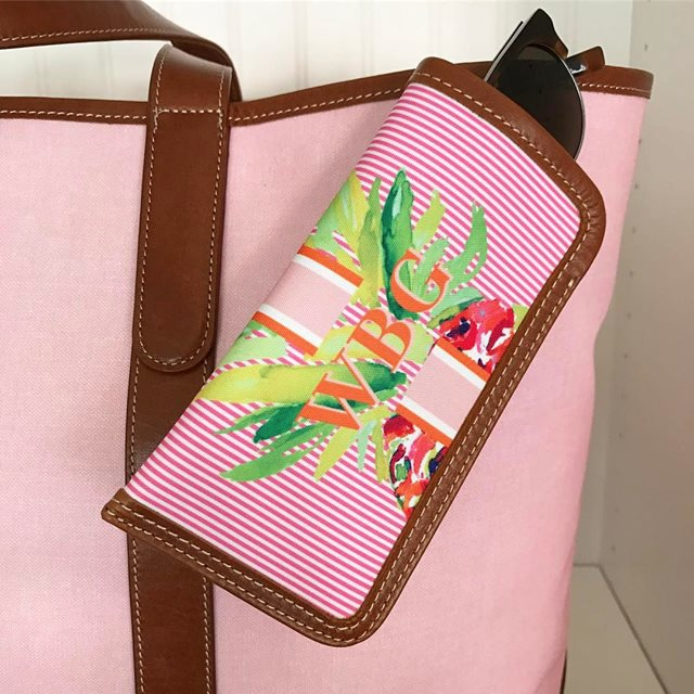 Chic striped canvas glasses case with personalized monogram, combining fashion with function.