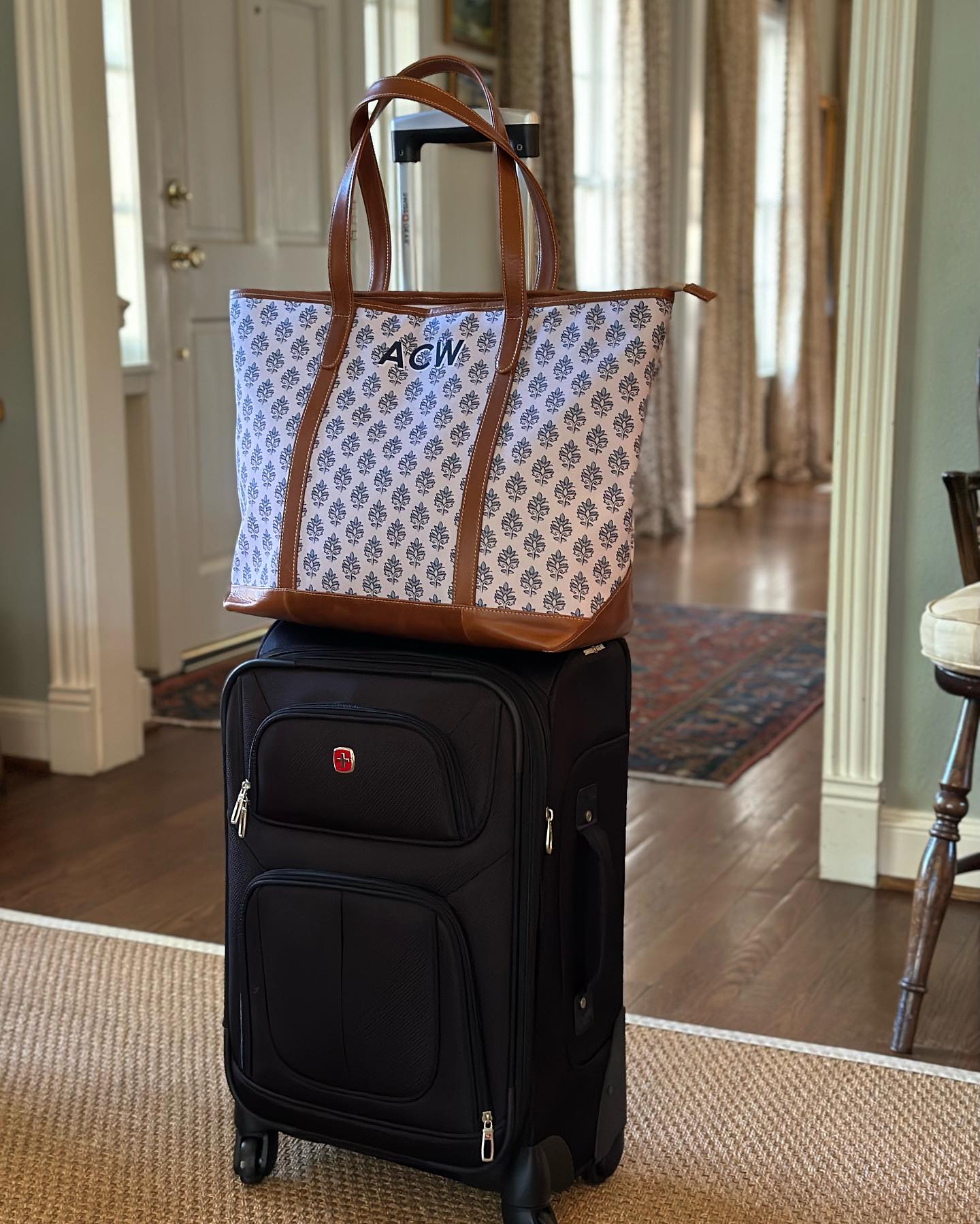 Front view of a stylish personalized monogrammed tote bag with a practical trolley sleeve, a type of monogrammed tote bag.