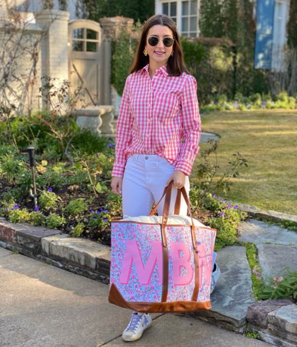 Woman carrying a large, stylish monogrammed tote bag in a vibrant pattern, an ideal personalized gift from our monogrammed tote bags range.