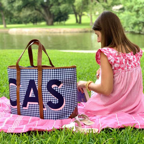 Young girl enjoying a picnic with a large, versatile monogrammed tote bag, perfect for work, play, and family outings.